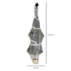 Hanging grey mummy decoration with spider web wrap and glowing eyes, posable arms
