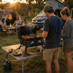 Black portable tabletop gas grill with open lid and two front burner control knobs