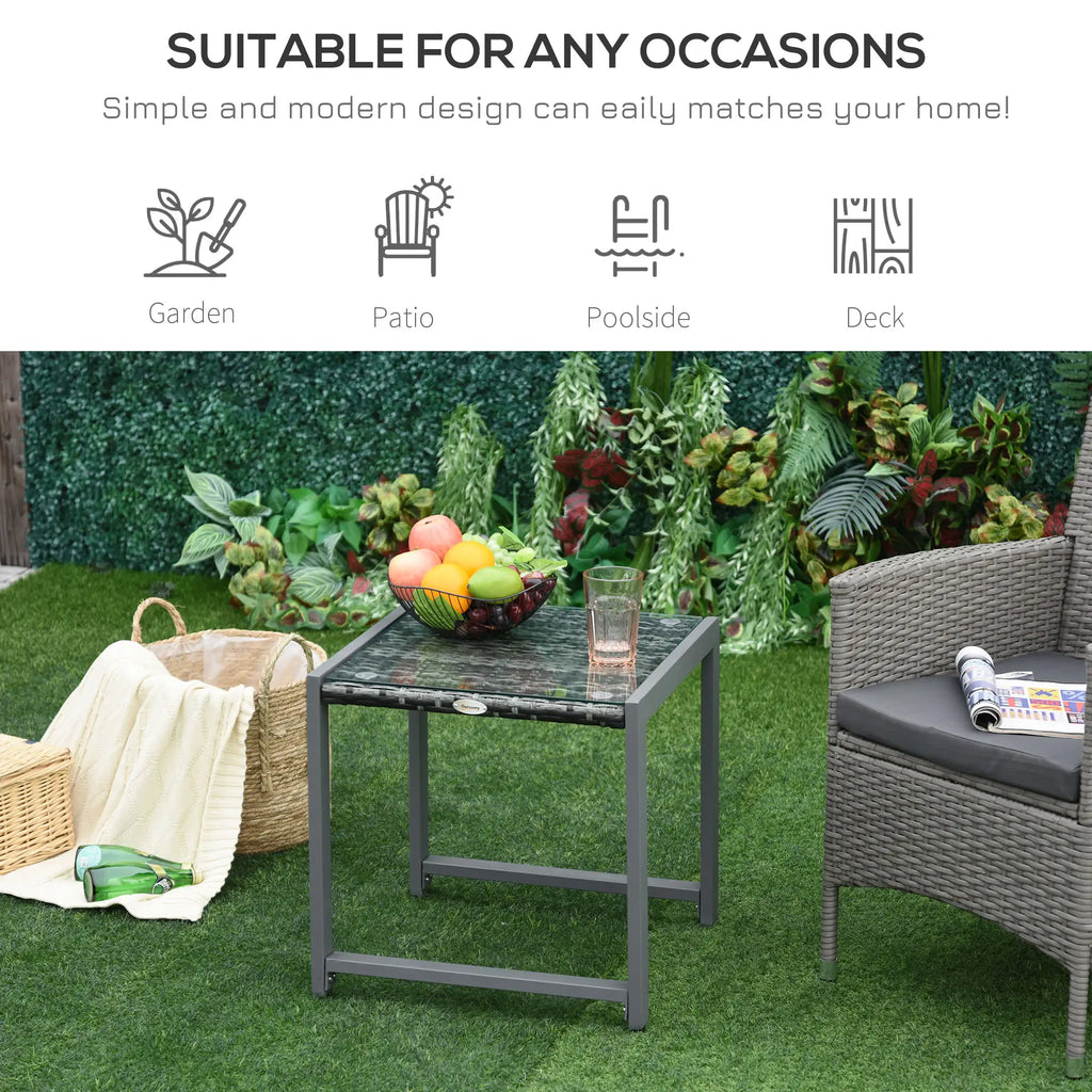 Grey wicker end table shown in a garden patio setting
