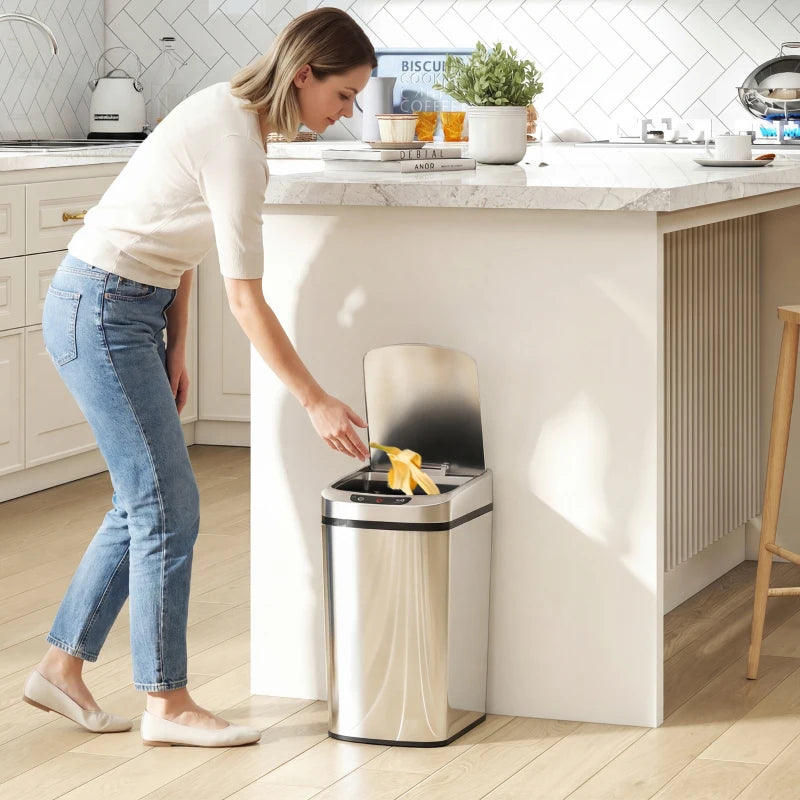 Silver stainless steel automatic touchless sensor trash bin standing in kitchen with lid open