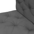 Close-up of dark grey padded seat cushion with tufted channels and stitched seams
