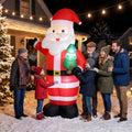 Inflatable Santa decoration in red and white stripes holding a glowing green mini tree