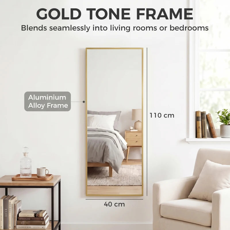 Full-length rectangular wall mirror with gold-tone frame, vertical orientation.