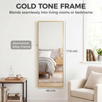 Full-length rectangular wall mirror with gold-tone frame, vertical orientation.