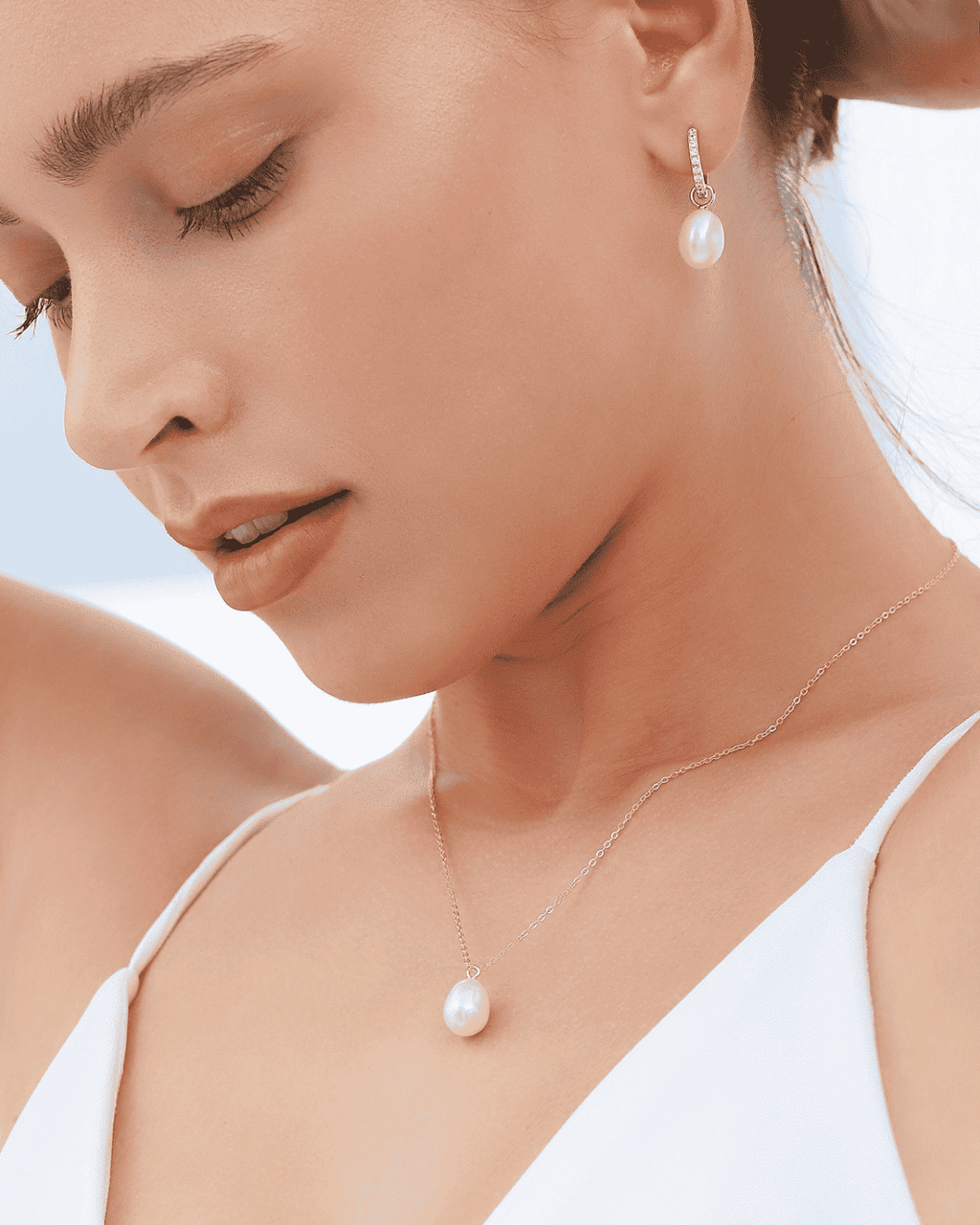 Gold vermeil teardrop freshwater pearl pendant and matching earring worn on model