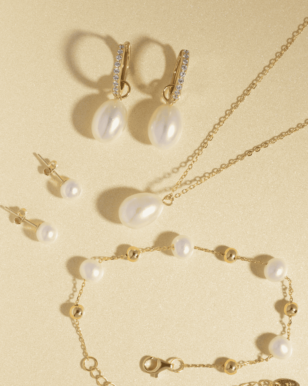 Gold vermeil freshwater pearl bracelet with round white pearls on gold chain, flat lay