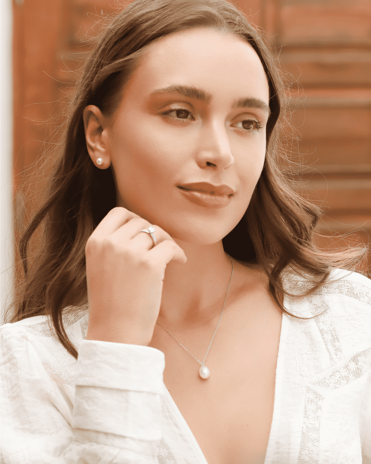 Woman wearing sterling silver teardrop freshwater pearl pendant necklace