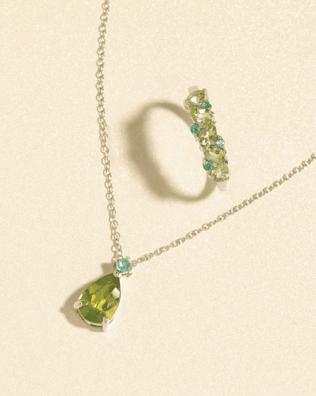 Sterling silver pendant necklace with two pear-cut green stones and small accent beads