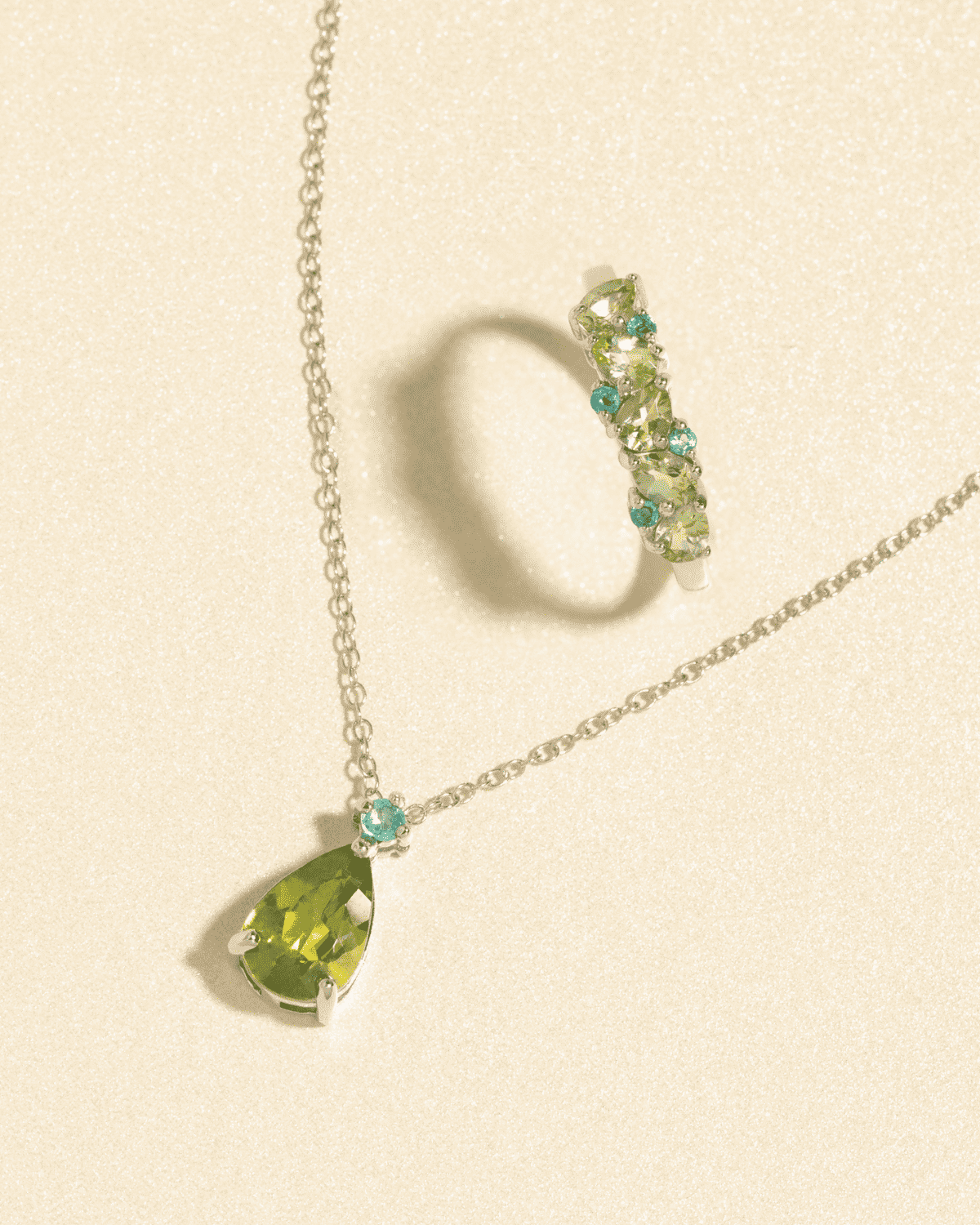 Sterling silver pendant necklace with two pear-cut green stones and small accent beads