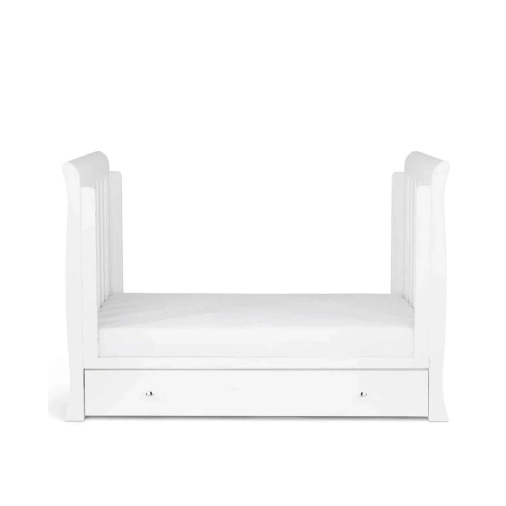White toddler bed with high rails and low front drawer, front view