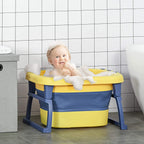 Yellow and navy baby bathtub with stool-style legs, toddler sitting in soapy water