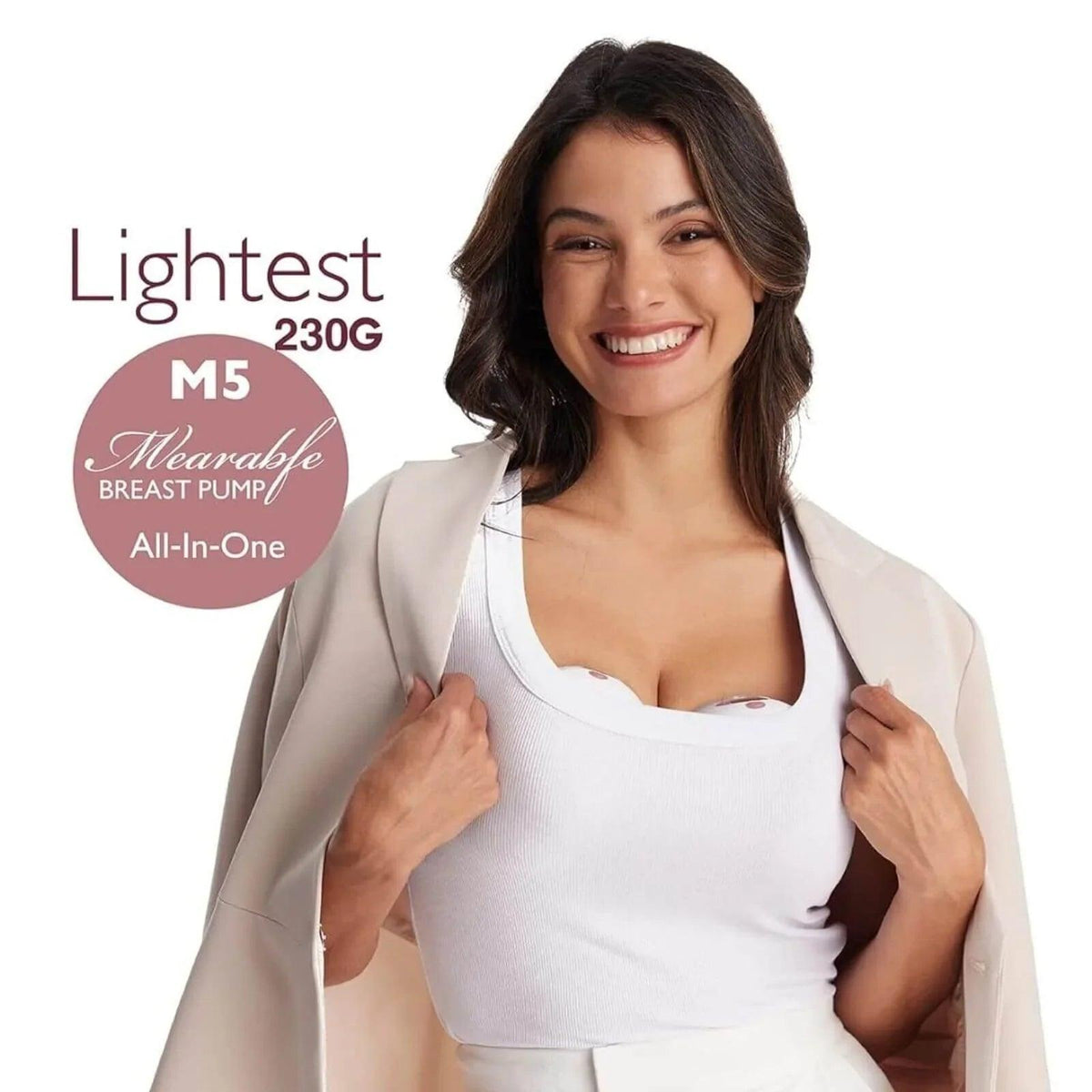 Woman wearing a white wearable electric breast pump over a nursing bra