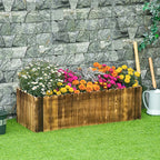 Wooden raised garden bed planter box filled with colorful flowers outdoors