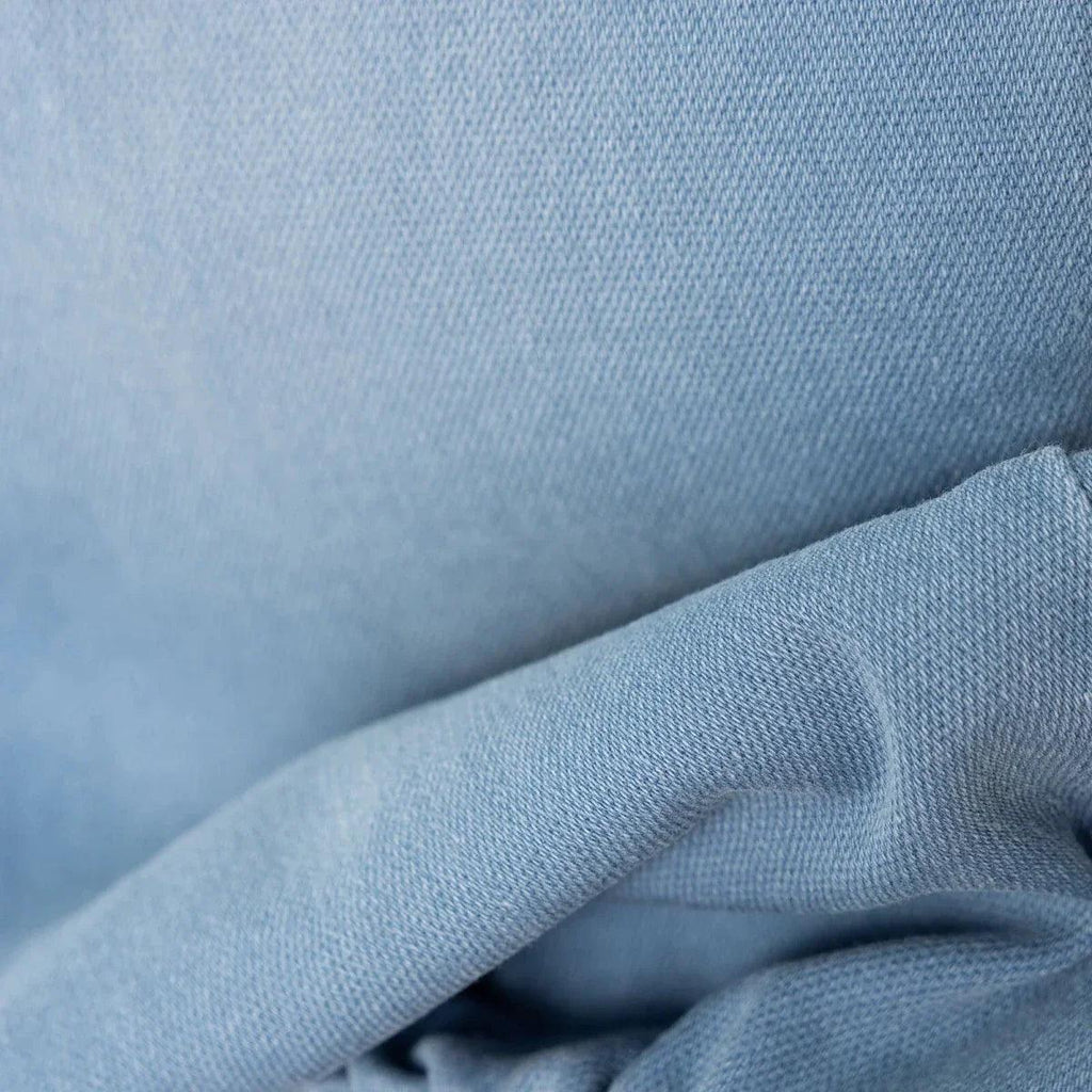 Light blue denim fabric close-up showing textured weave