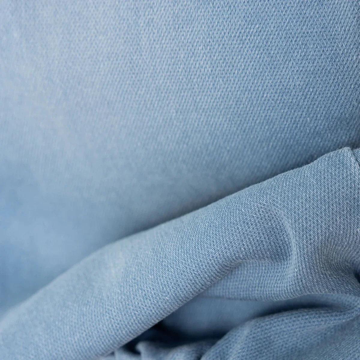 Light blue denim fabric close-up showing textured weave