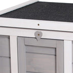 Grey wooden hutch close-up of open roof latch and handle above front doorway