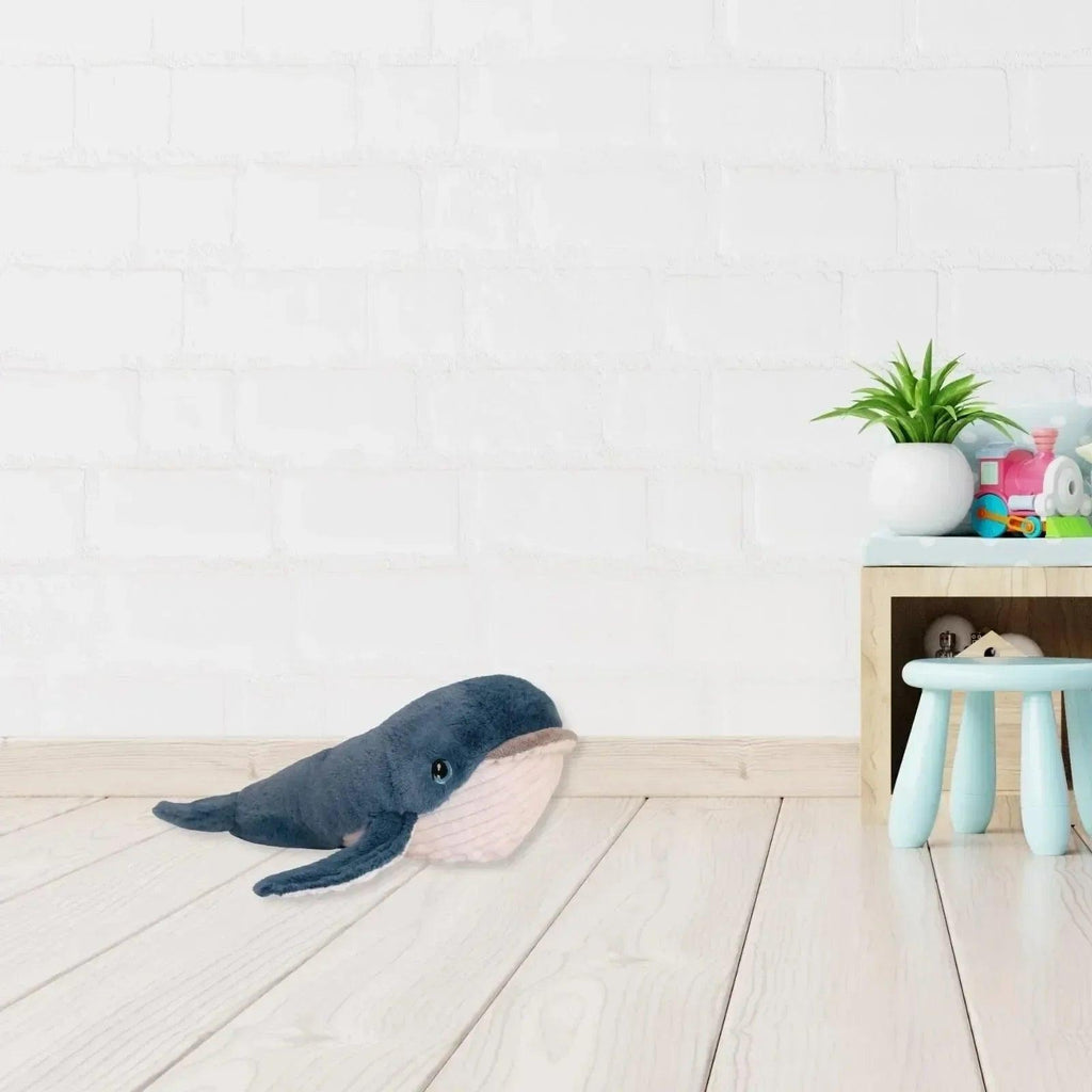 Blue and white plush whale toy with embroidered eye and textured belly