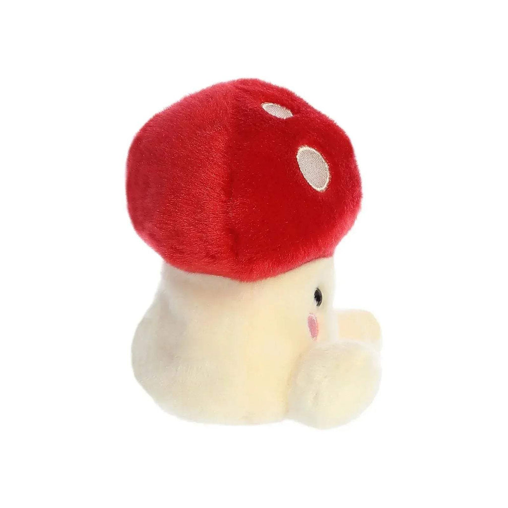 Red mushroom plush in side view with cream body and cute face detail