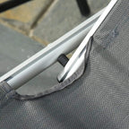 Dark gray lounge chair with aluminum frame and woven fabric strap detail