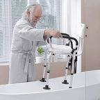 White shower chair with backrest and padded flip-up arms beside a bathtub
