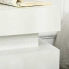 Close-up of white high-gloss drawer front on a two-drawer bedside table