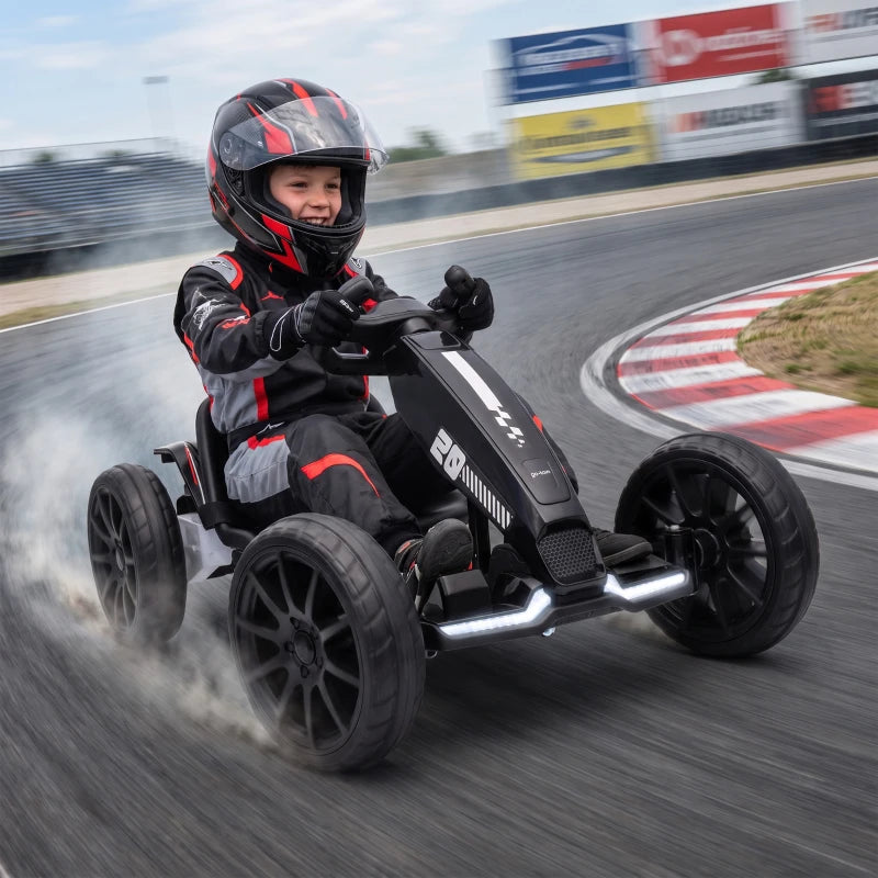 Black electric kids go kart with rider drifting on track, rear wheels spinning