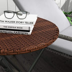 Brown woven rattan tabletop edge with black legs on foldable round side table