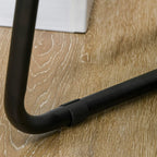 Black metal leg with anti-slip foot pad attached to charcoal grey fabric sleeper chair