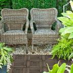 Charcoal grey patio decking tiles in a garden seating area on interlocking panel floor