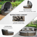 Round PE rattan daybed with open retractable canopy and dark grey seat cushion