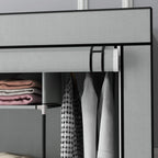 Dark grey fabric wardrobe interior with hanging clothes and folded storage on shelves