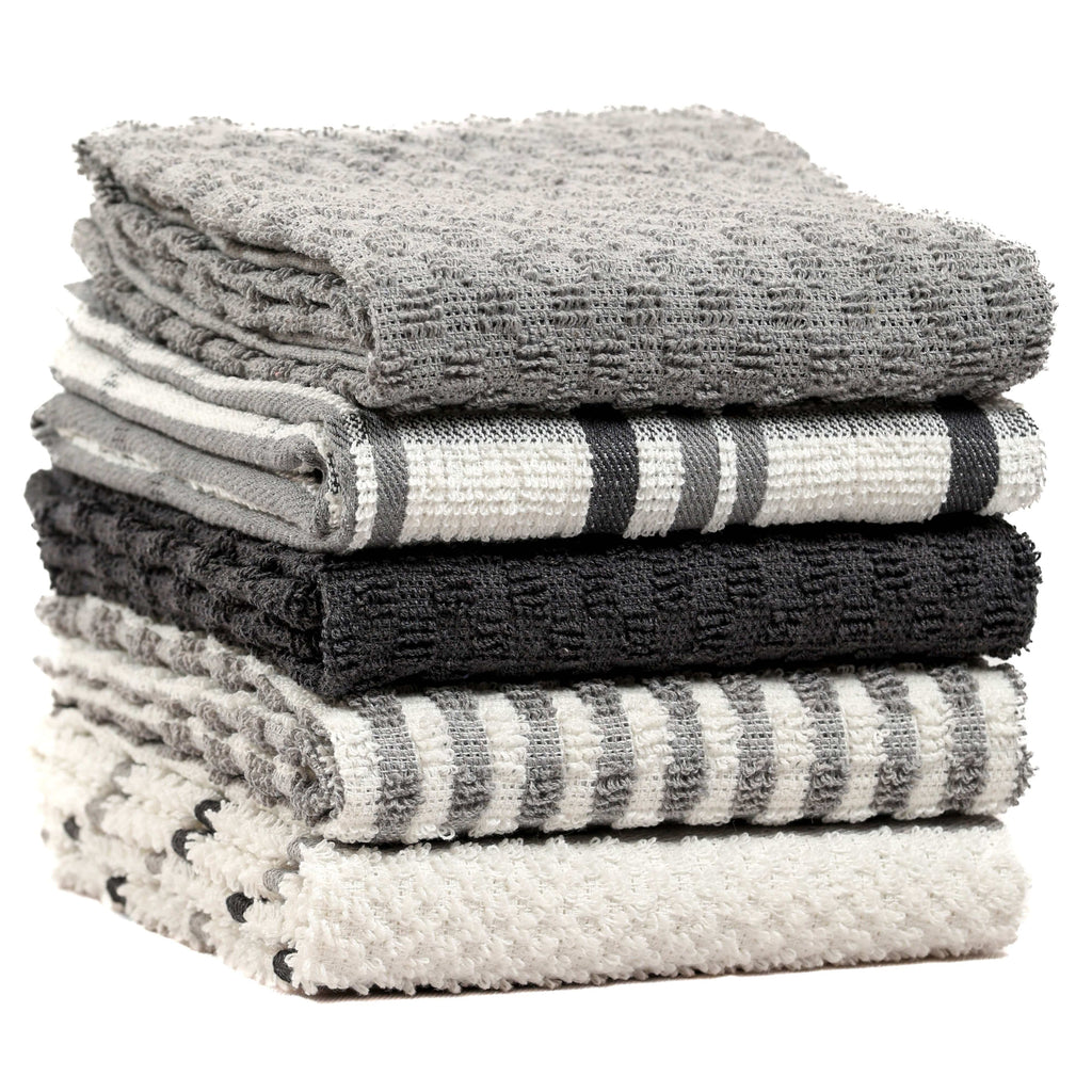 Stack of terry kitchen towels in grey tones with stripes, check and textured solid panels