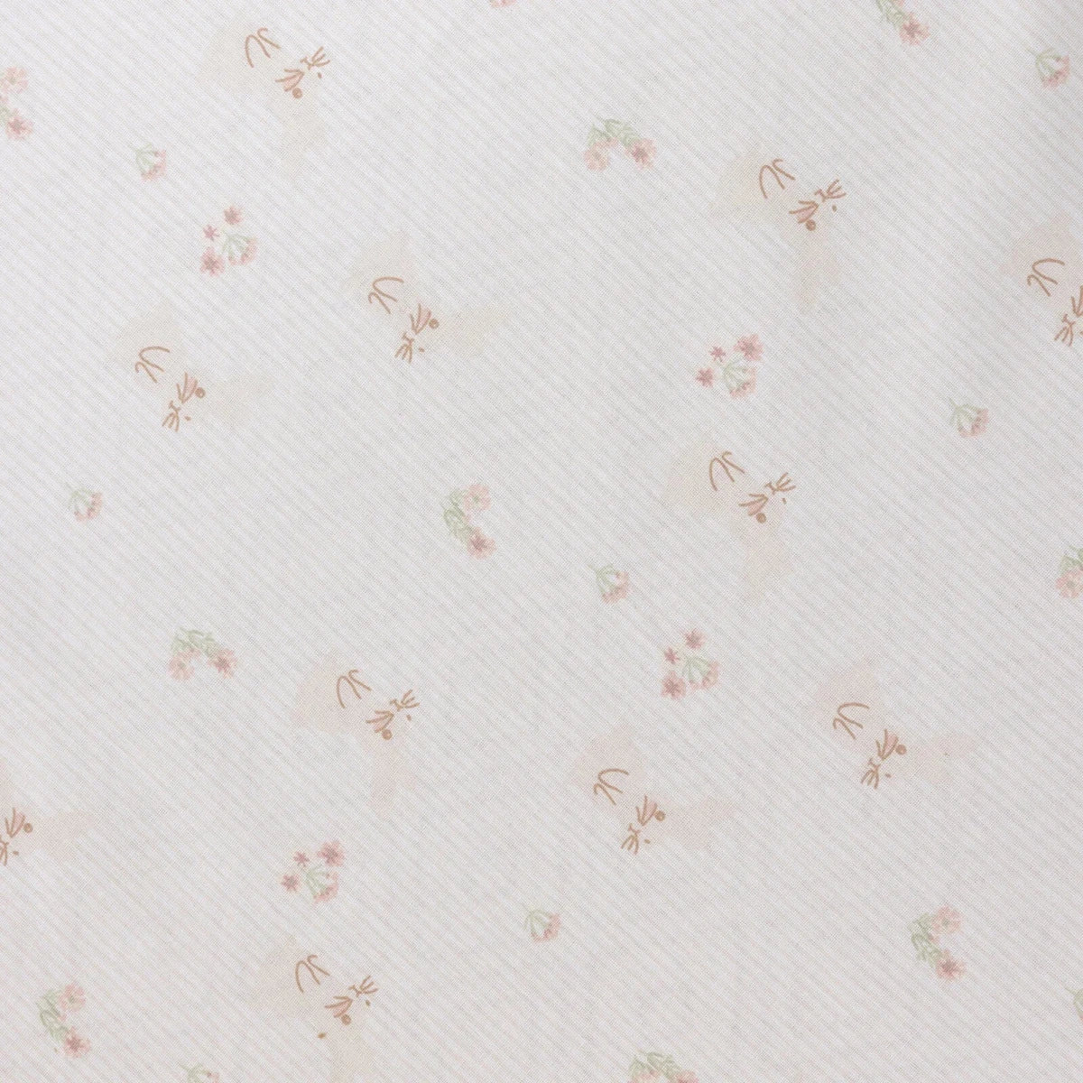 White baby sheet close-up with fine texture and small pastel floral print
