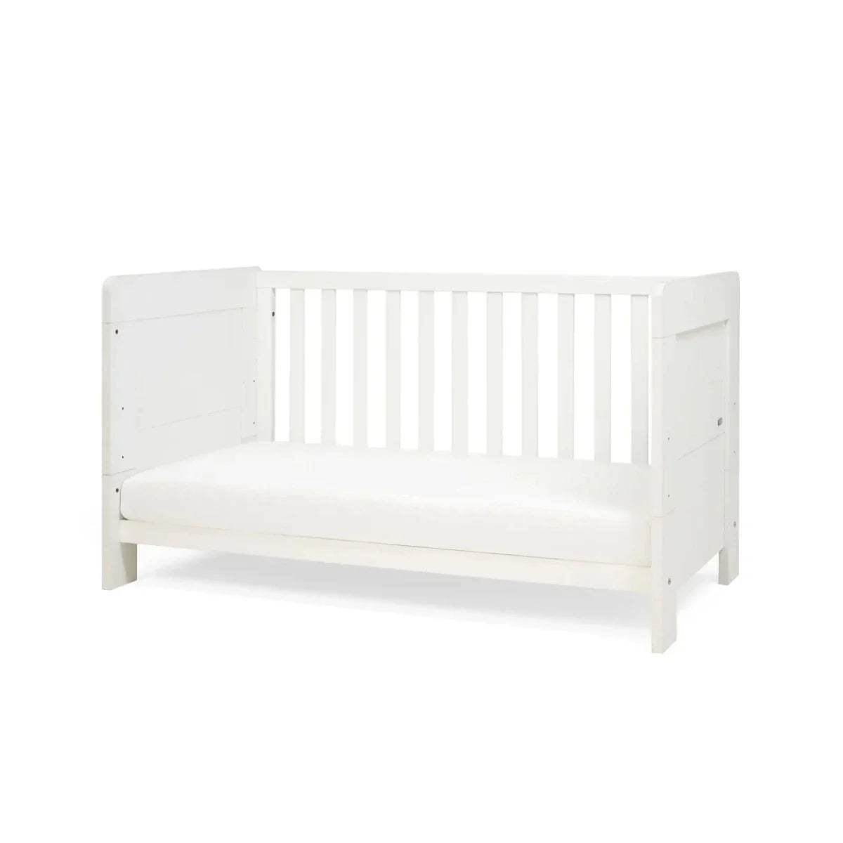 White convertible bed with vertical slat rail and padded white mattress cover