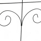 Black metal fence corner knot detail connecting two vertical bars.