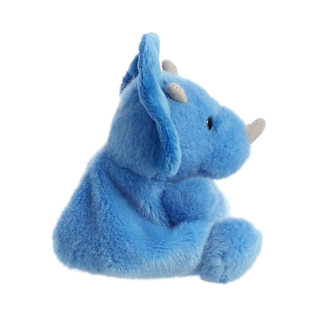 Blue plush triceratops soft toy, side view, cream facial scales, lying down
