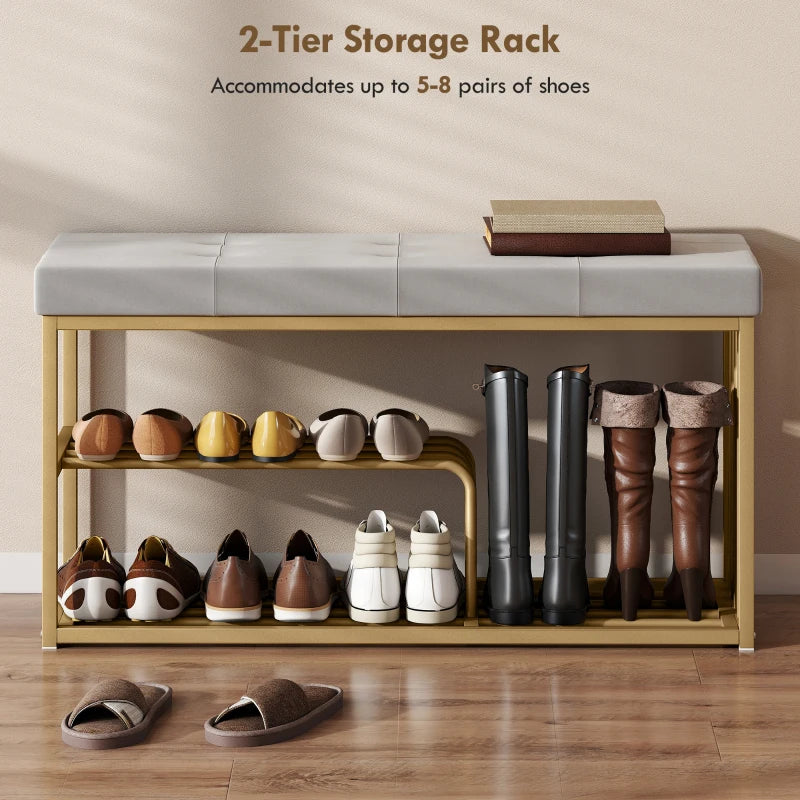 Grey tufted shoe bench with gold steel frame holding shoes on two-tier shelves