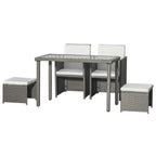 Grey rattan-style dining set with rectangular glass top, two armchairs, and two stools