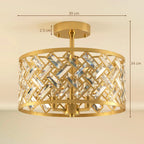 Gold-tone flush mount ceiling light with circular frame and crystal prism accents