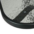 Square tempered-glass tabletop edge with black frame, showing umbrella hole area