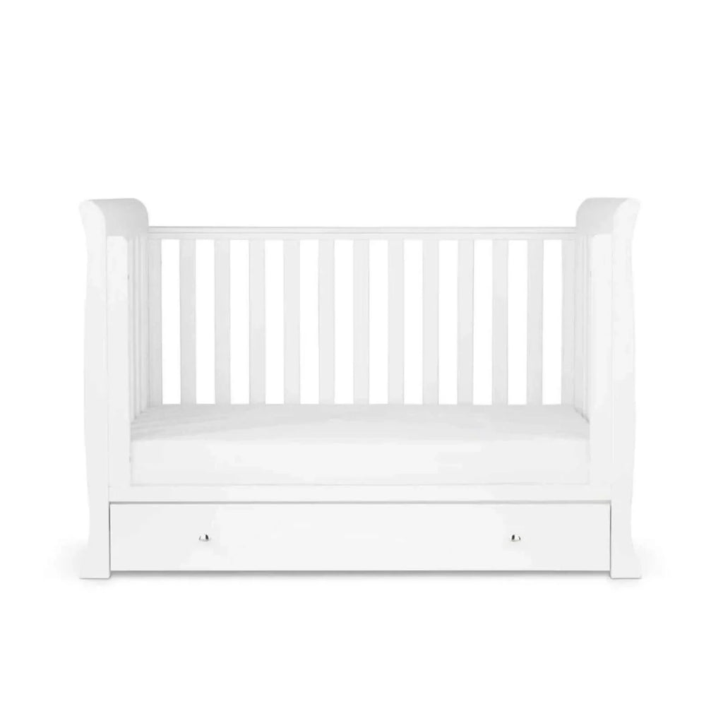 White mini cot bed with mattress in base position and front drawer panel