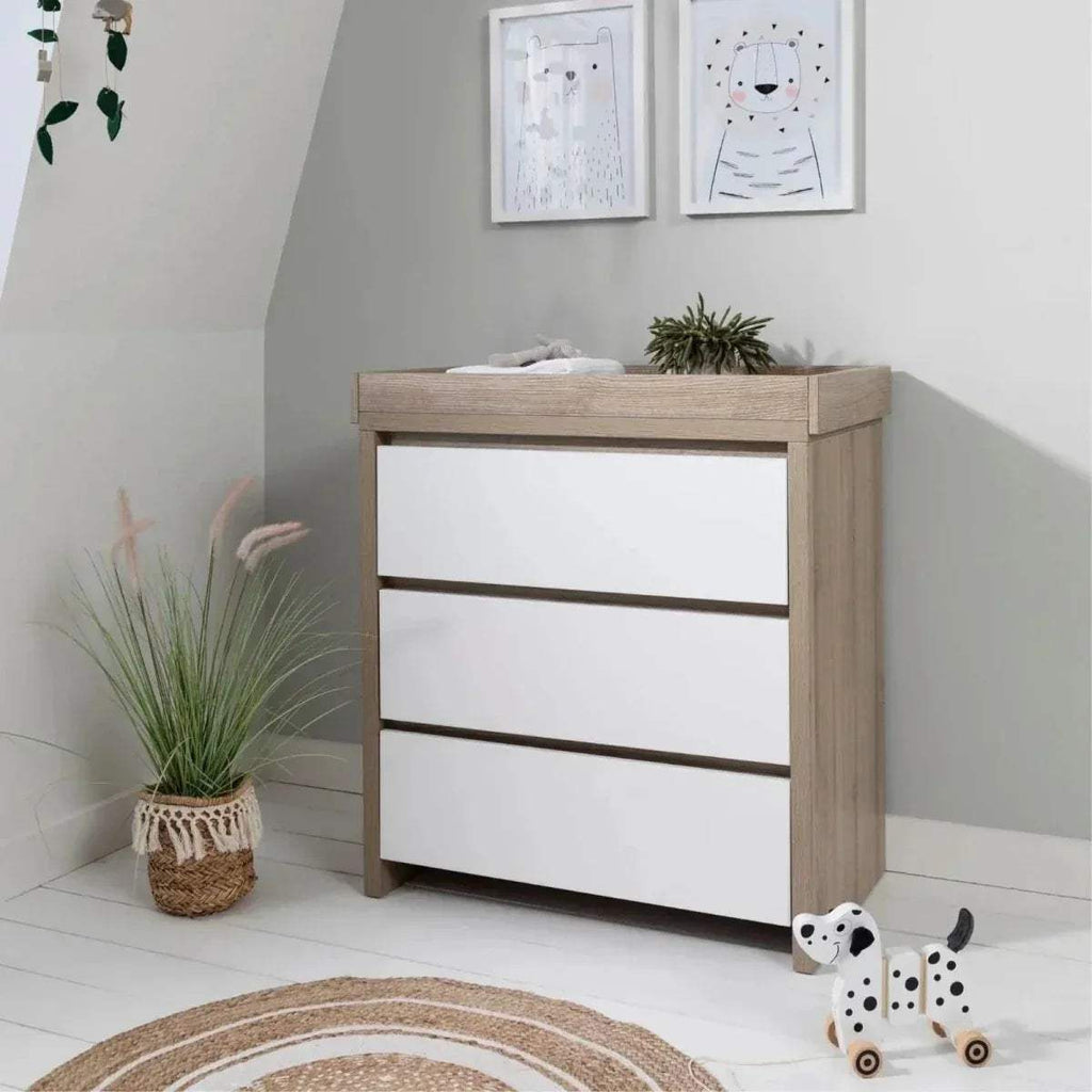 White and light oak changing unit with three panel shelves and top changing surface