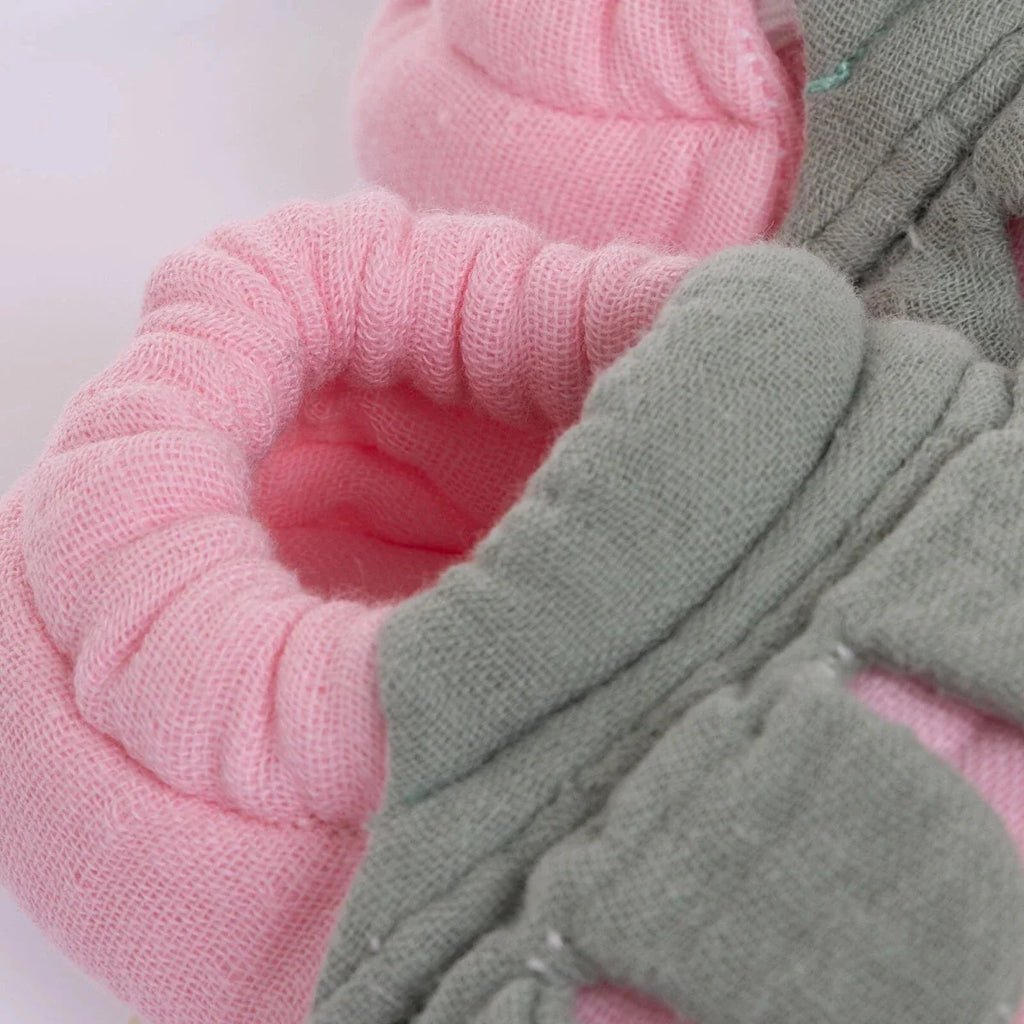 Pink knitted baby bootie with ribbed cuff