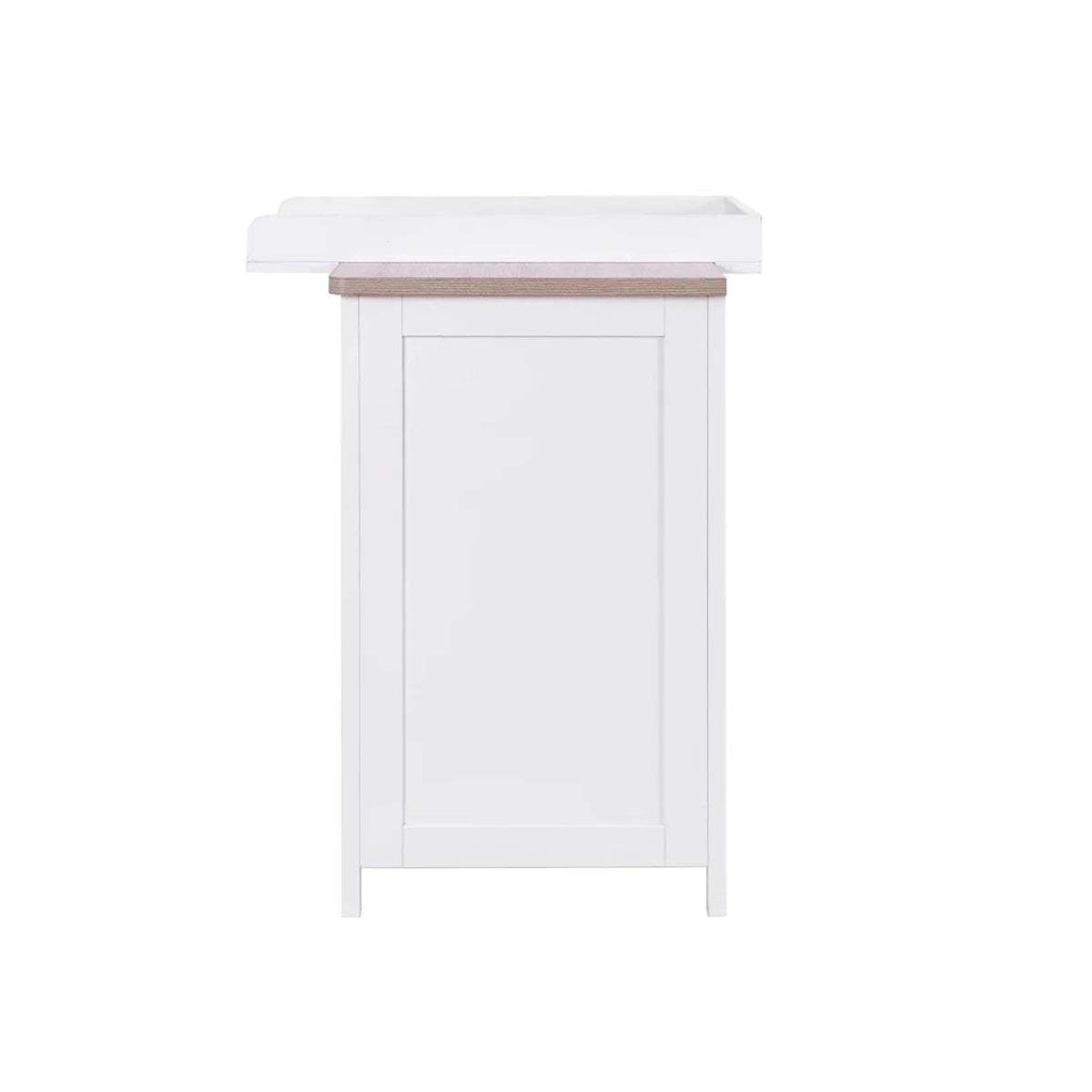 White changing dresser side view with oak-toned top rail and front cabinet panel