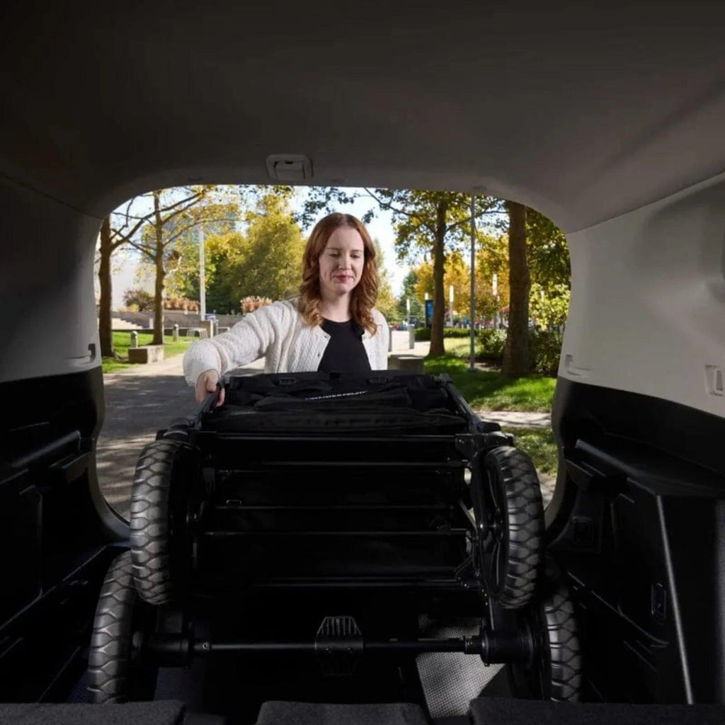 Jet black stroller wagon interior view with canopy and wheel housings