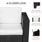 Black rattan armchair with padded backrest, white cushion, and wide armrests