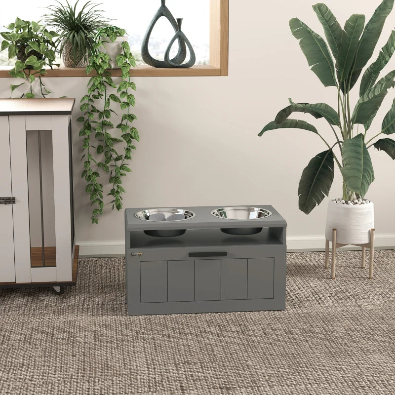 Grey raised dual dog bowl stand with two stainless steel bowls in an indoor space