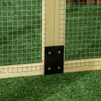Close-up of wooden chicken run latch hardware on wire mesh side panel