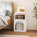 White bedside table corner view with open shelf and arched front storage compartment