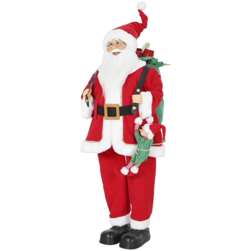 Standing red Santa figure with white beard, black belt, holding green sack and gift
